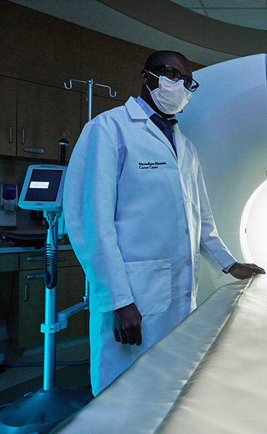 Specilaist standing with state-of-the-art CT Scanner.